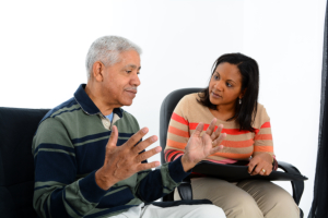 caregiver talking to senior man